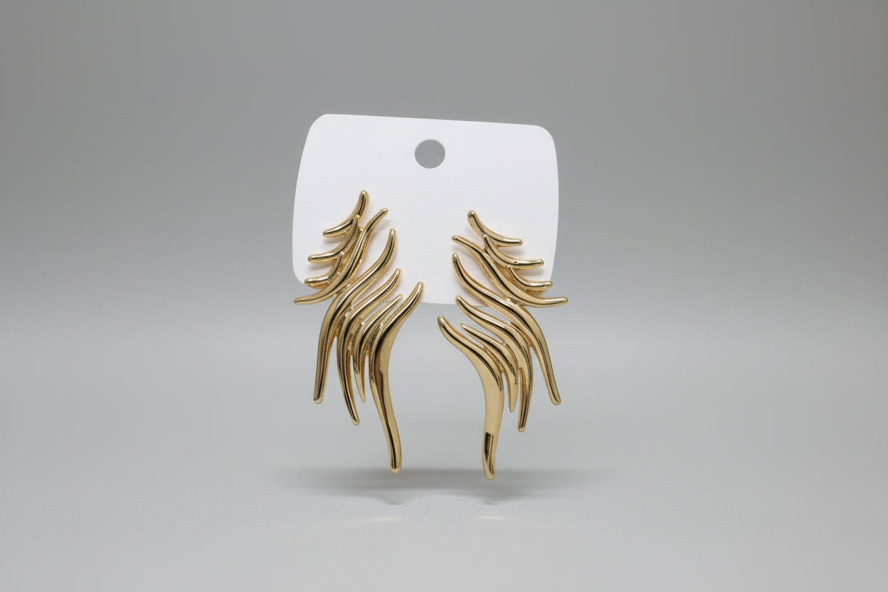 Angled view of sculptural fluid wave earrings in a polished gold finish with anti-tarnish protection