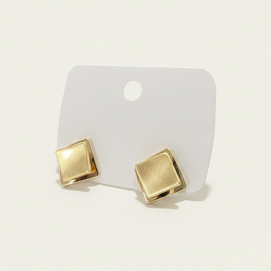 Side view of geometric diamond-shaped gold studs showing the polished and matte stainless steel finish