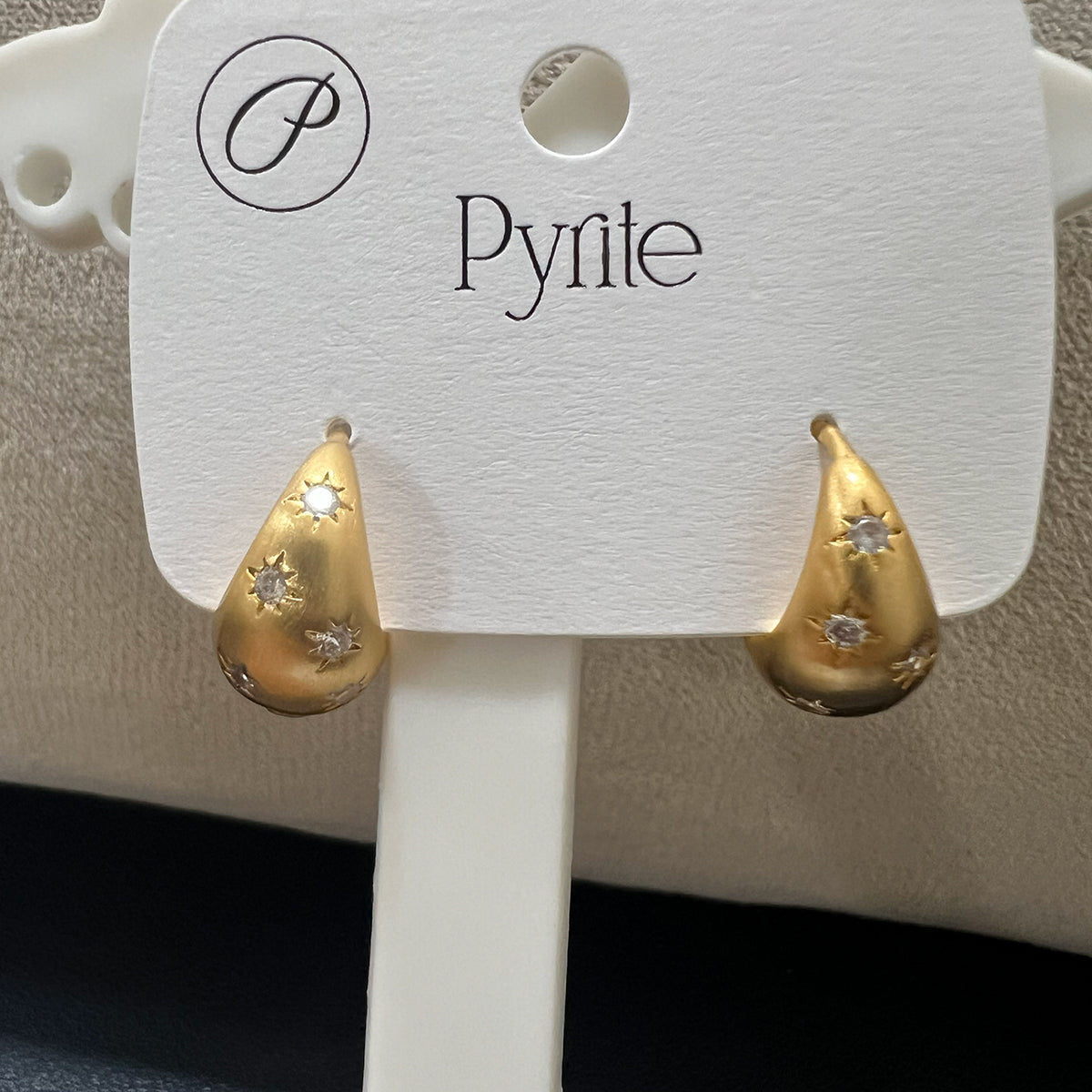 Side profile of anti-tarnish stainless steel earrings with a premium matte gold finish and starburst details