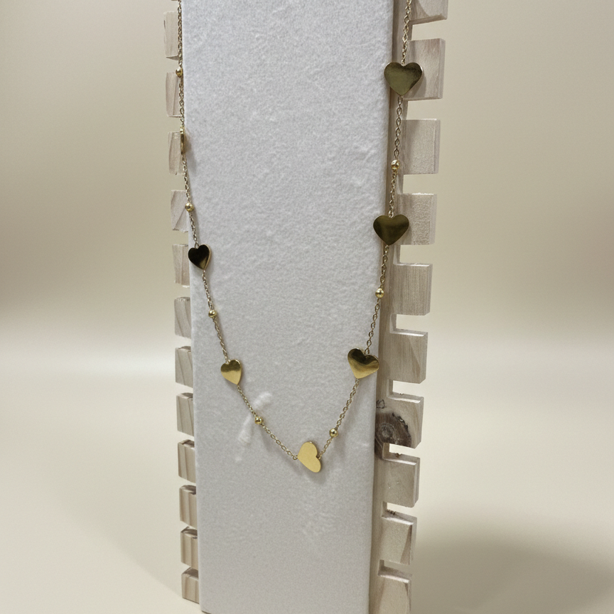 Minimalist gold plated station necklace featuring seven flat heart charms and golden beads on a dainty chain