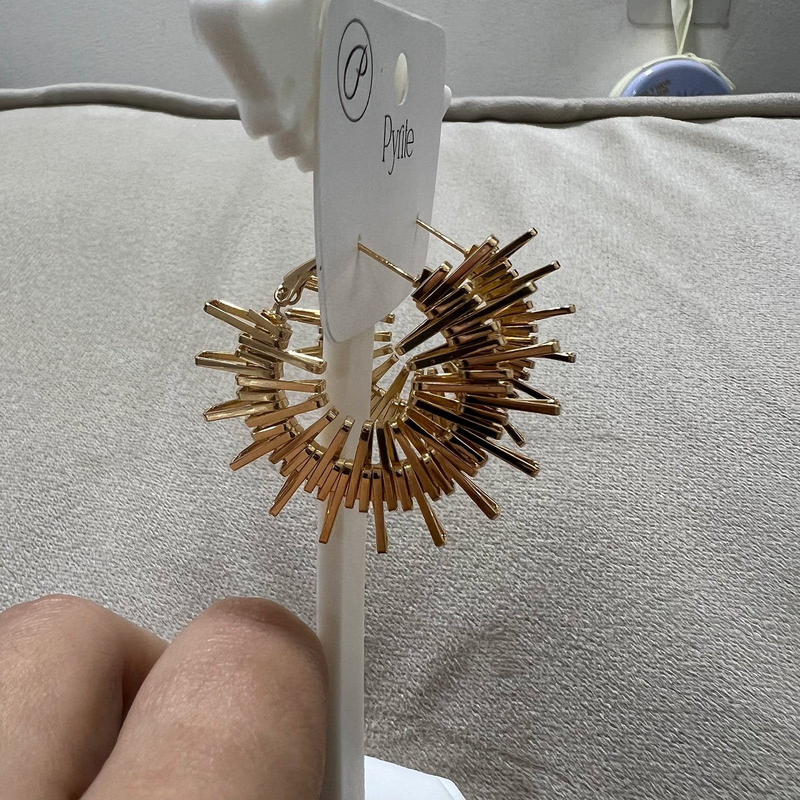 Side profile of premium stainless steel gold-toned burst earrings showing the intricate architectural spiked detail