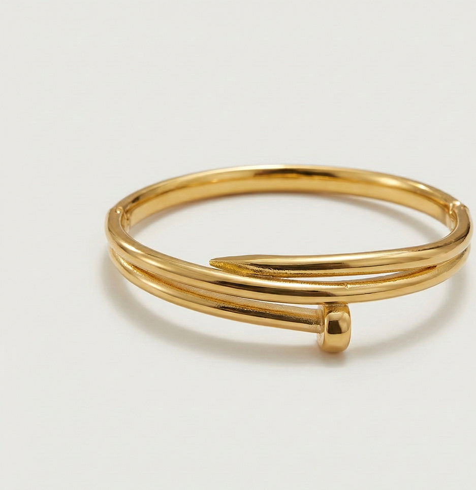 Top-down view of a polished gold-plated nail bangle crafted from durable, tarnish-free stainless steel