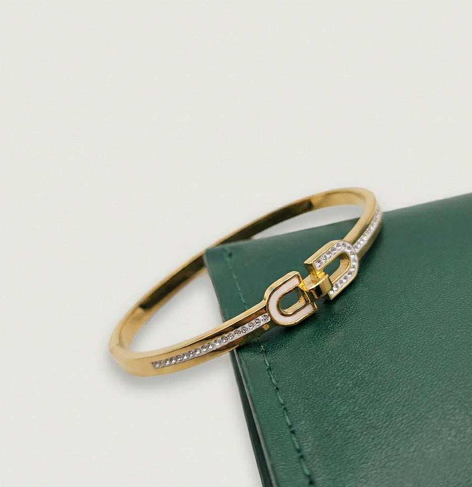 Angled view of a premium gold plated link bracelet featuring shimmering crystals and a hinged closure