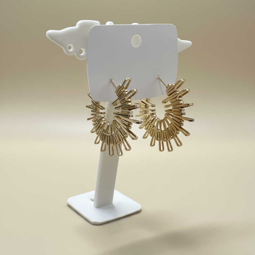 High-shine gold plated sunburst hoop earrings with a fringe design made of metallic bars on a white stand