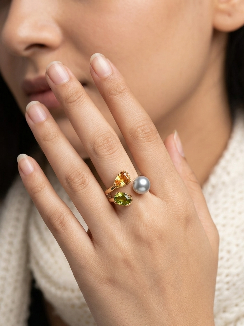 Multi-gemstone gold open ring with pearl, peridot, and champagne stones.