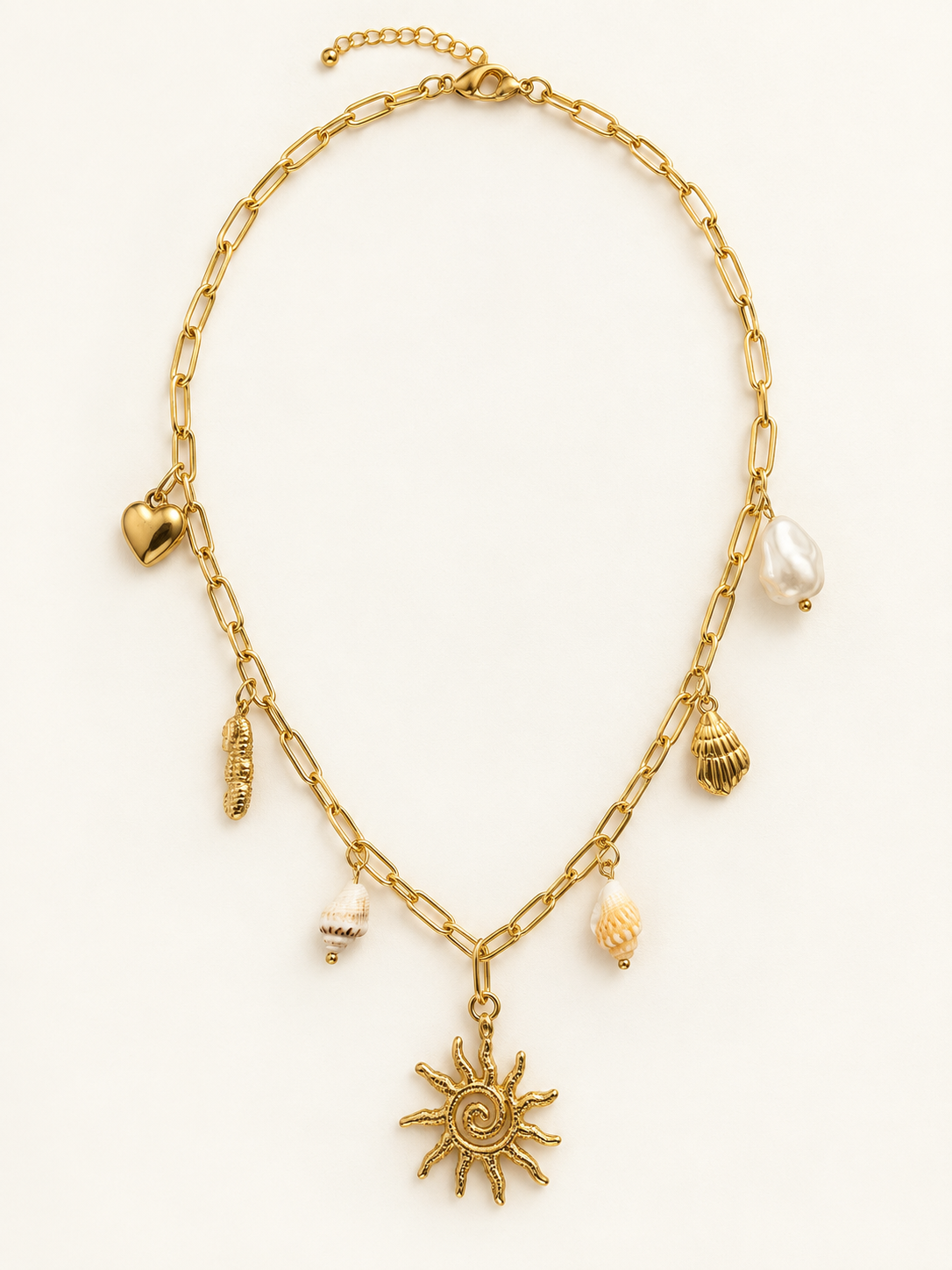 A gold-tone chain necklace with various shell and sun pendant charms, displayed on a clean white background.