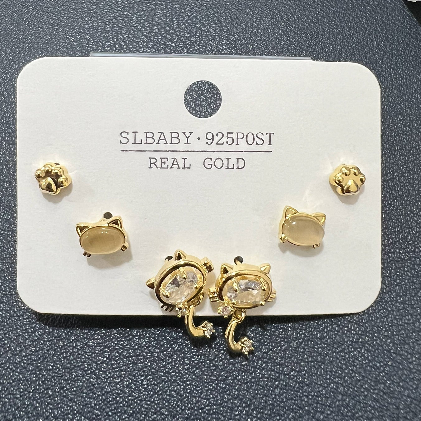 Side-angled view of durable stainless steel cat-inspired stud earrings showcasing a lustrous gold finish.