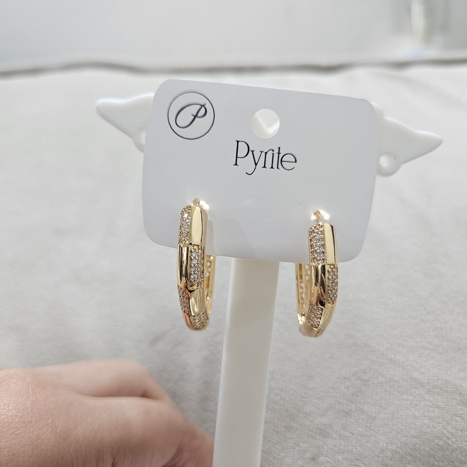Side view of anti tarnish stainless steel gold earrings showing the unique angular design and polished finish