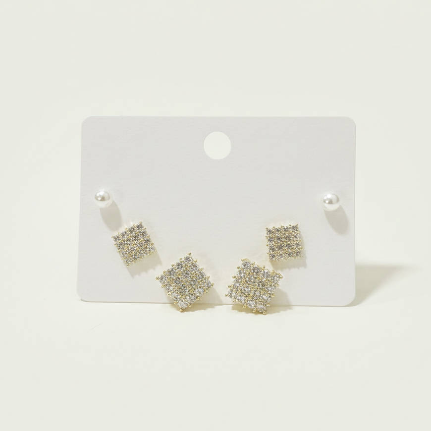 Set of two pairs of gold plated square pavé stud earrings displayed on a white product card.