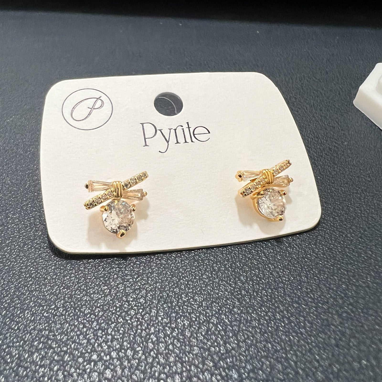 Close-up view of tarnish-free stainless steel ribbon earrings showing detailed baguette and pavé stone settings