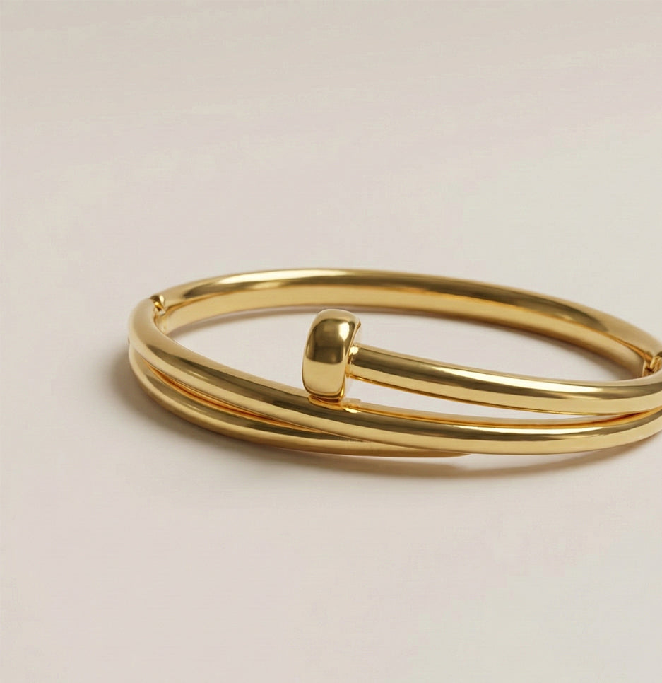 Side perspective showing the elegant nail head detail of a premium gold finish stainless steel bracelet
