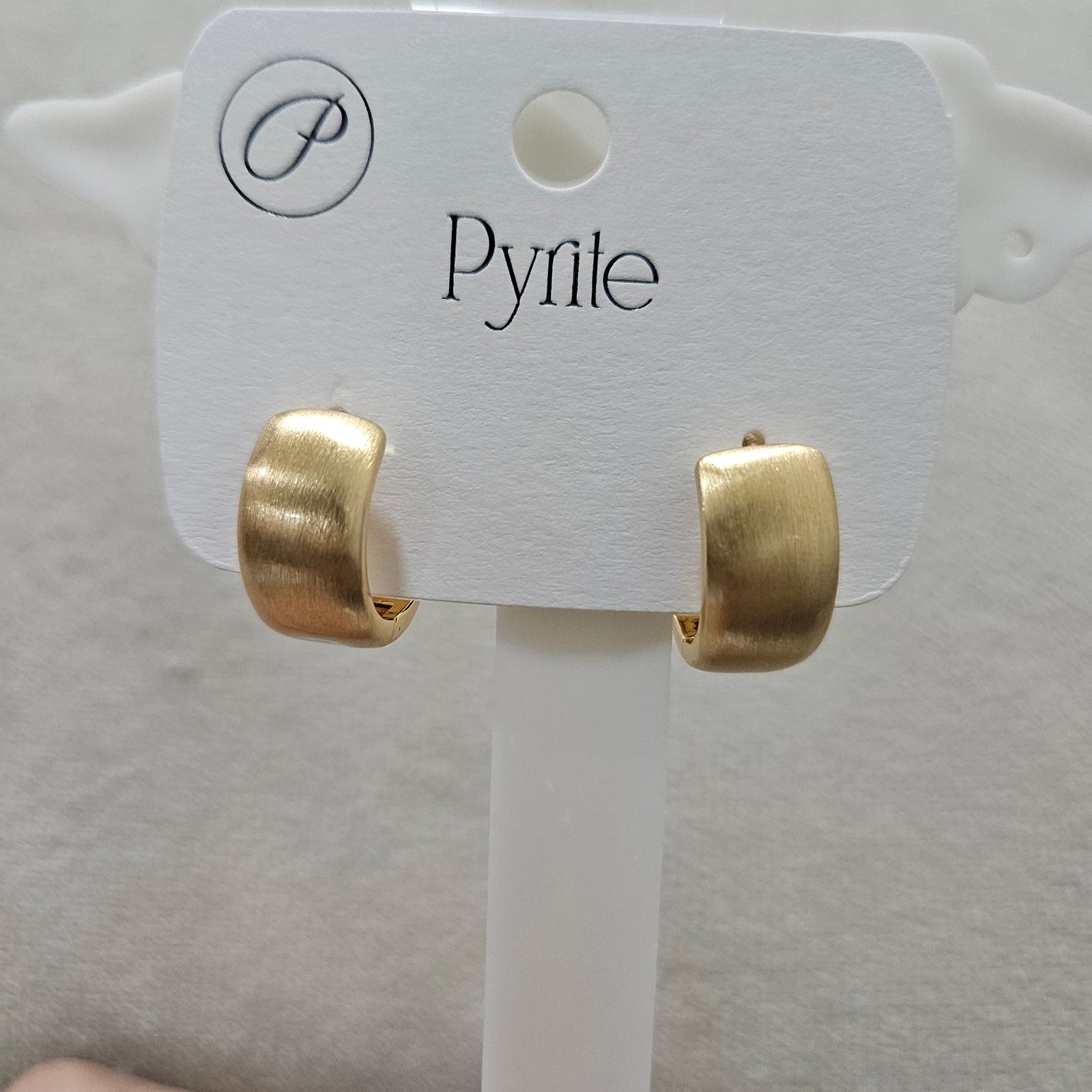 Close up side view of gold plated anti-tarnish stainless steel hoop earrings highlighting the secure hinge.