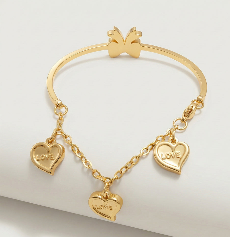 Detailed side view of a premium gold-toned bracelet with a crystal bow resting on a green leather prop