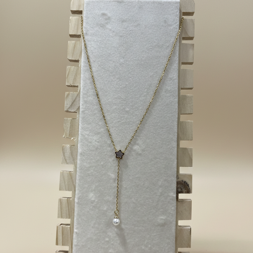Anti-tarnish gold Y-necklace with a celestial star and pearl pendant shown on a professional wooden jewelry stand